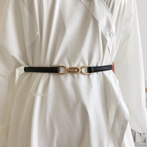 A Pair Of Buckles Belt Womens Fine Decoration Dress Matching worn over a white outfit, featuring a stylish black design.